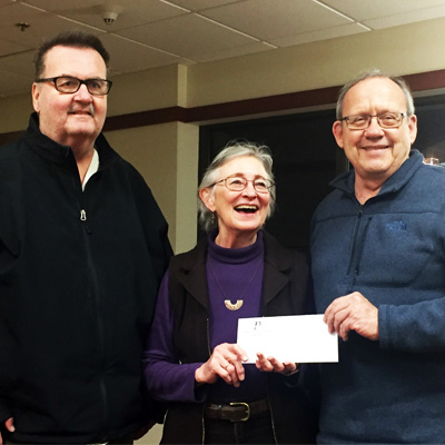 Positvely Portage members (Mike Hurd, Rich Jacobson presenting a check to Betty Kutzke of The Portage Center for the Arts